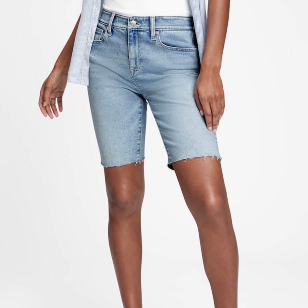9” mid-rise distressed denim Bermuda shorts with washwell.